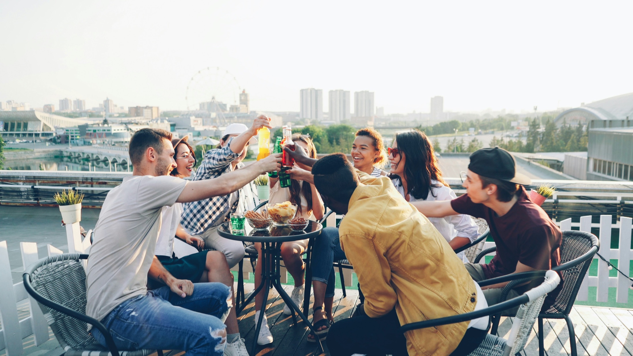 Friends gathering around a table and raising their glasses